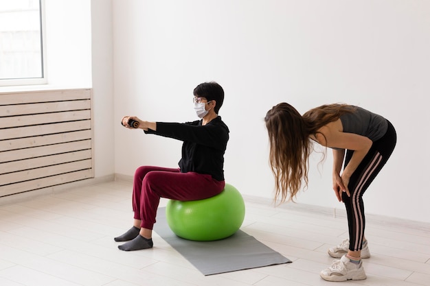 Person doing balance exercises on a yoga mat at home