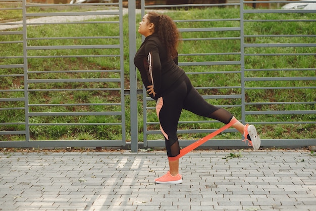 Person practicing balance exercises near a park path