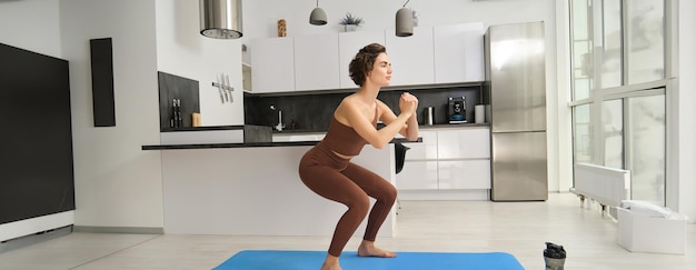 Person performing bodyweight squats at home