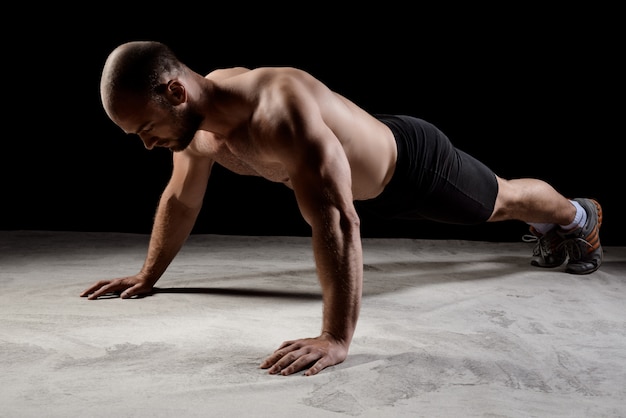 Traveler doing bodyweight exercises in a hotel room