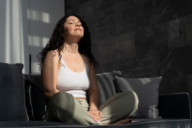Woman practicing breathwork at home