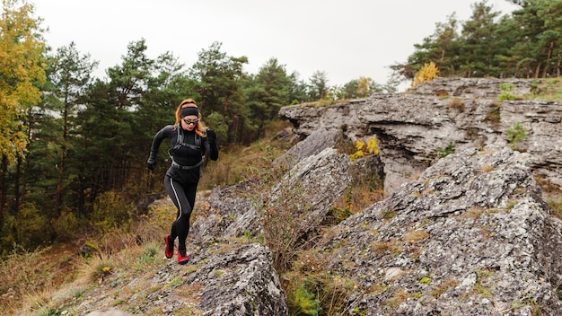 Runner on a forest trail maintaining a steady pace
