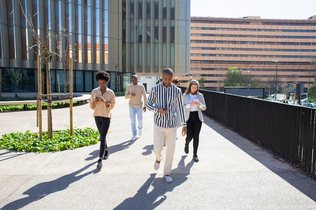 Two professionals walking and talking in a park