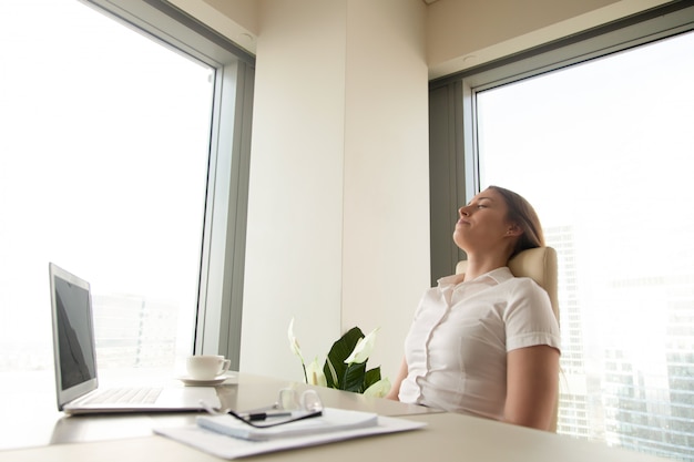 Office worker practicing deep breathing at their desk