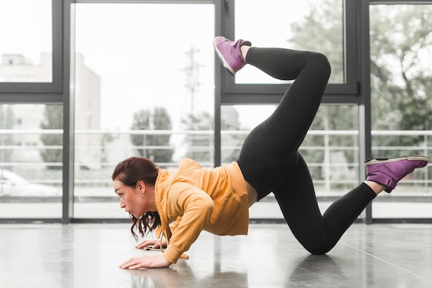 Person performing a jump squat in a home workout