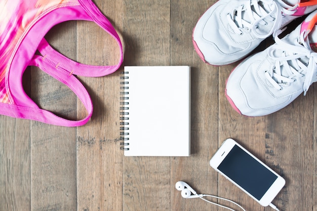 Hand marking a fitness calendar with a checklist