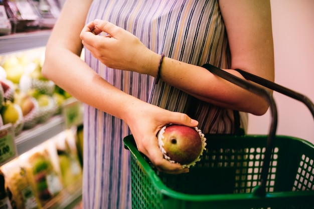Shopping cart filled with vegetables, fruits, and whole grains