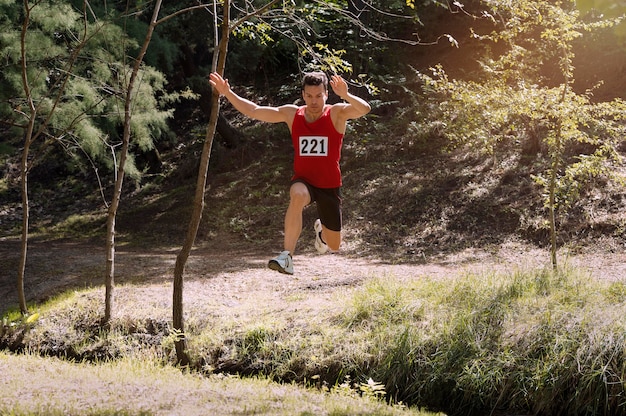 Runner sprinting uphill on a grassy slope