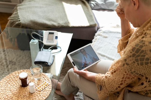 Blood pressure monitor, water bottle, and journal on a table