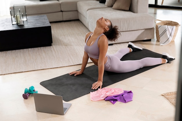 Person exercising on a yoga mat at home