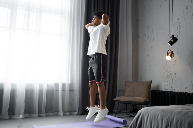 Person doing bodyweight squats in a hotel room with resistance band