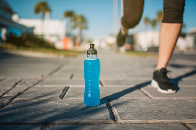 Person walking outdoors with water bottle