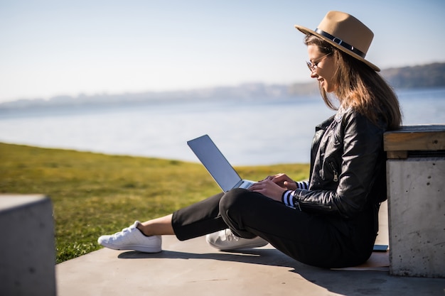 Traveler using a laptop with ergonomic setup in a café