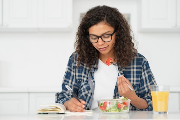 Student meal prepping with containers