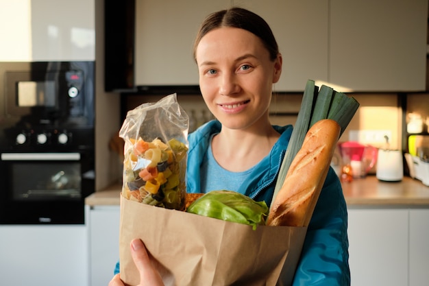 Organized grocery list and fresh produce in a shopping cart