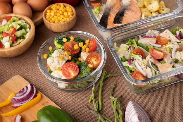 Someone preparing meals in a clean kitchen with containers and fresh ingredients
