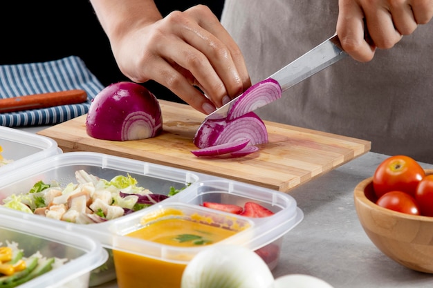 Step-by-step meal prep: chopping vegetables, cooking grains, portioning meals