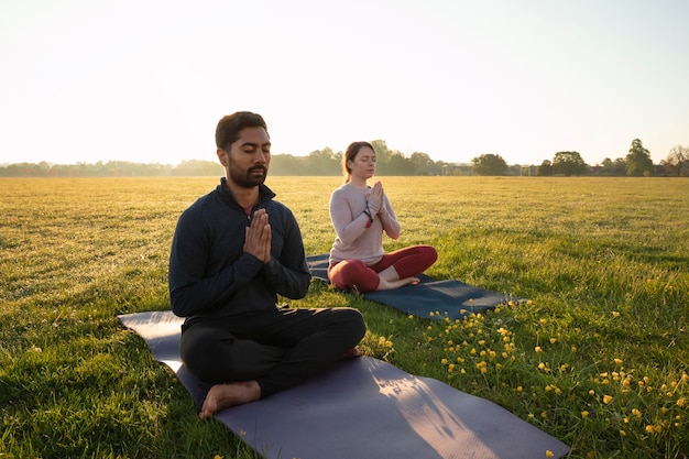 Person meditating in a peaceful outdoor setting