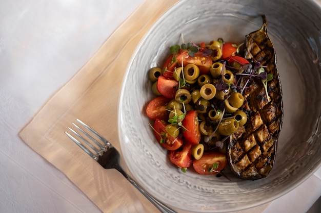 Colorful Mediterranean meal with vegetables, fish, and olive oil