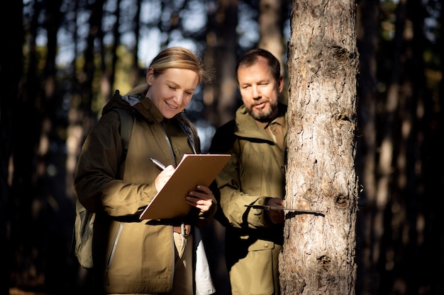 Wildlife officer examining a deer in the field