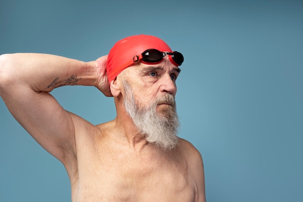 Middle-aged man swimming freestyle in pool