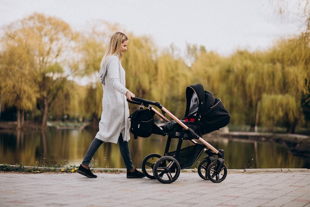 New mom jogging with a stroller in a park