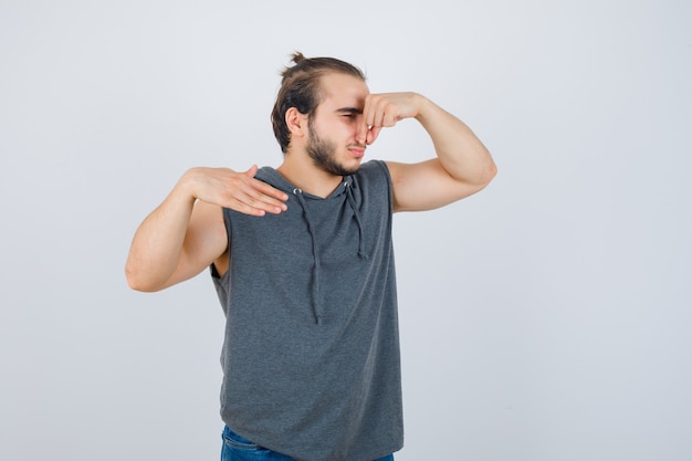 Woman using a tennis ball to release shoulder tension against a wall