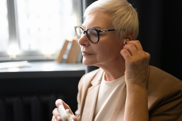 Senior using a hearing aid during a conversation