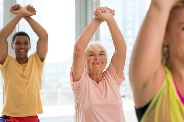 Older adults practicing light resistance training in a community center