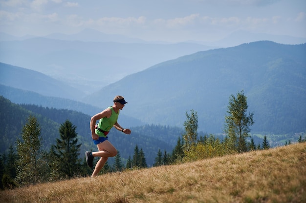 Runner ascending a hill in a park