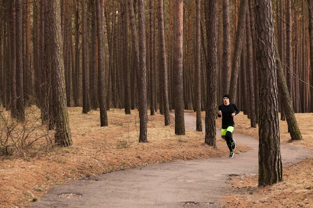Runner on a tree-lined trail enjoying nature