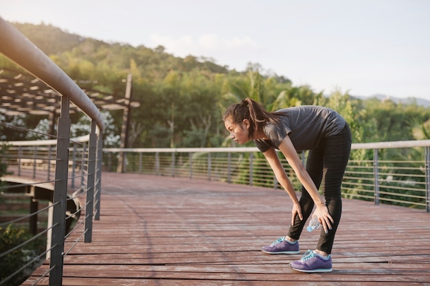 Runner performing static stretches on a mat