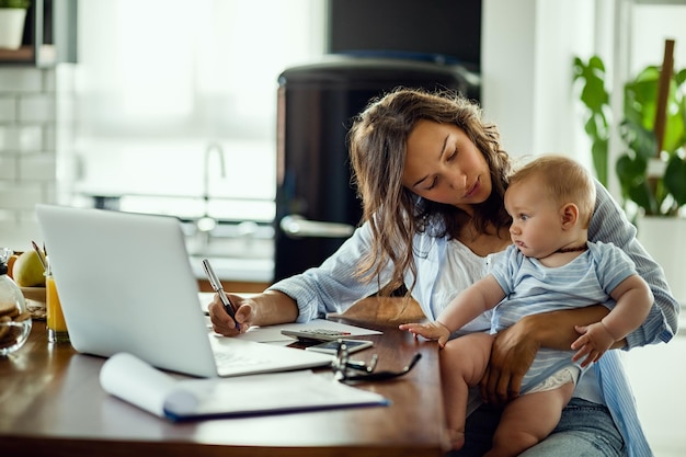 New mother working from home with baby nearby