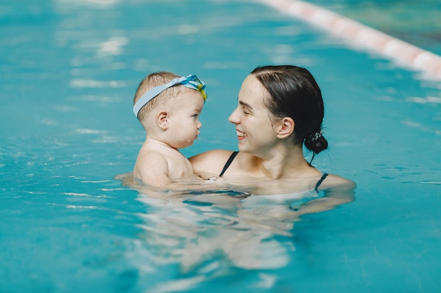 New mother swimming gently in pool