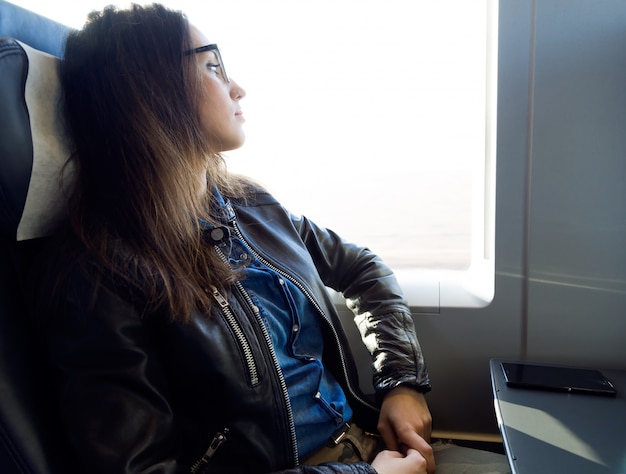 Traveler maintaining good posture while seated on an airplane