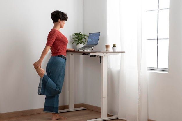 Woman practicing good posture while working at a laptop