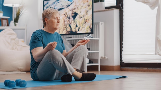 Person stretching on a yoga mat at home