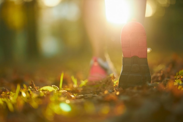 Person running on a trail at sunrise
