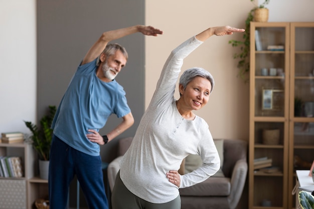 Senior performing gentle stretches at home