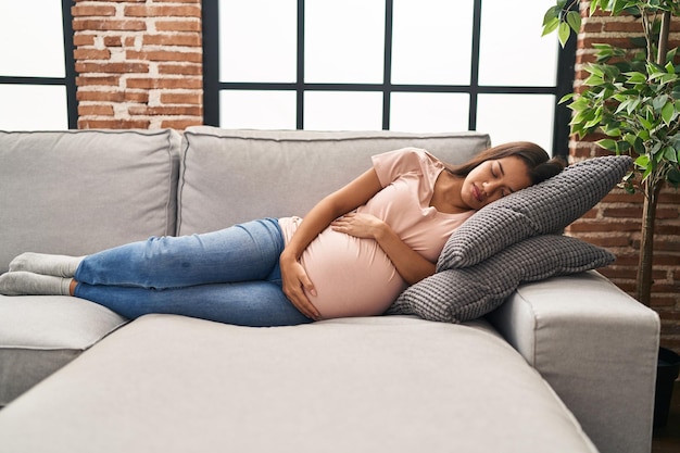 Pregnant woman sleeping with eye mask and pillow