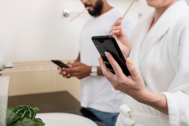Person using smartphone while sitting on toilet