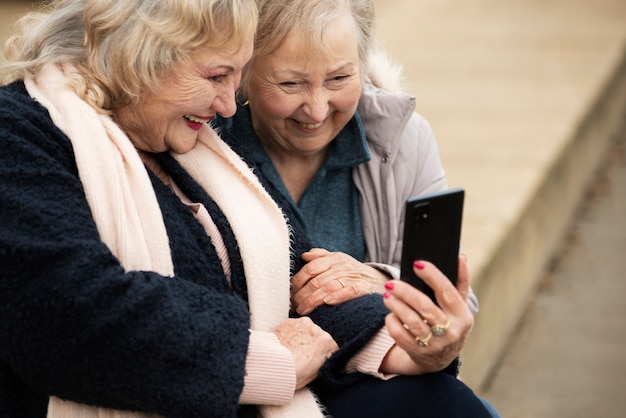 Group of seniors laughing and talking together in a park
