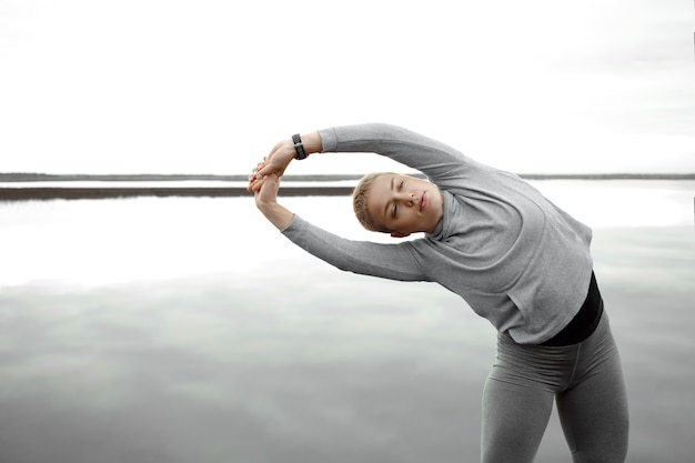 Woman doing a supported squat using a chair