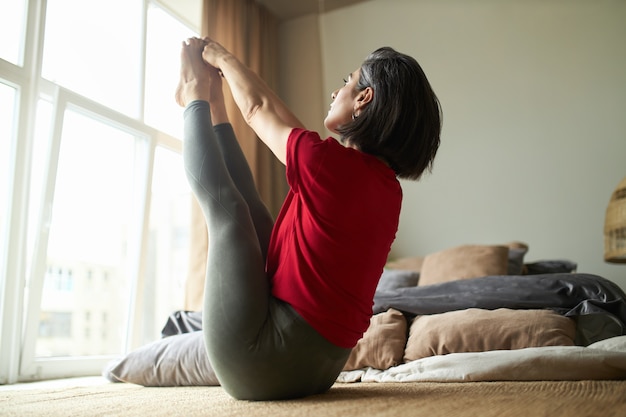 Student stretching in dorm room
