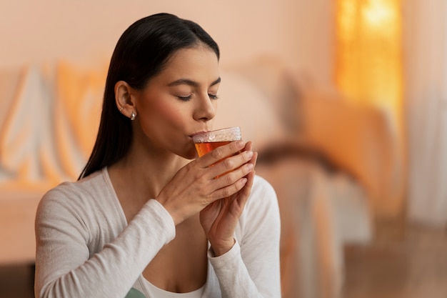 Person holding a teacup with a thoughtful expression