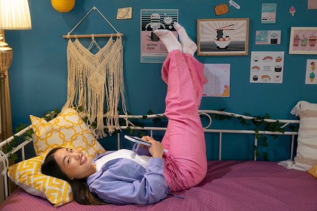 A tidy teen bedroom with dim lighting and a comfortable bed