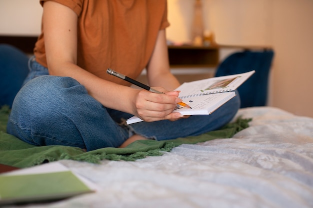 Teen writing in a journal with energy tracker