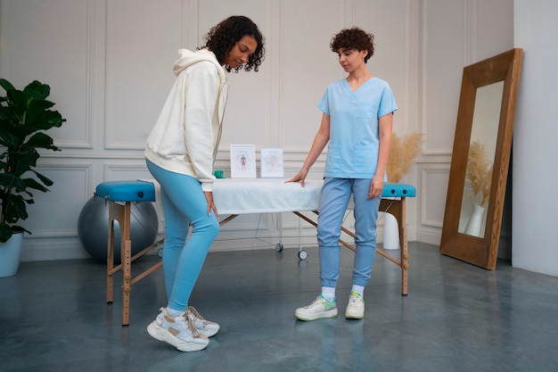 Teen doing physical therapy exercises with a coach