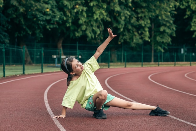 Teenager running on a track at sunset