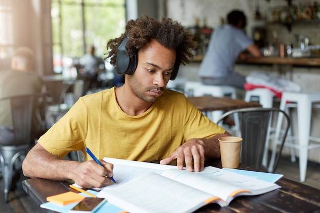 Teen studying at desk with tired expression